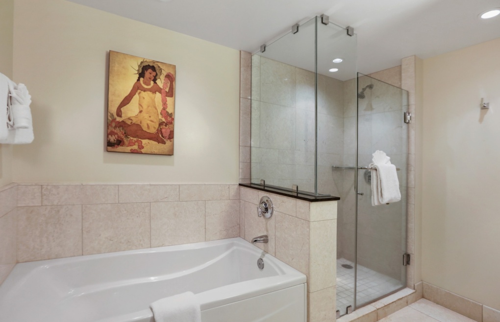 With a glass walk-in shower and a soaking tub