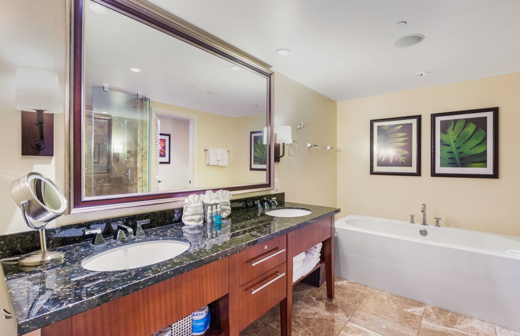 The luxurious master bathroom features an elegant freestanding tub