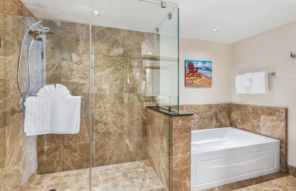With a glass and marble shower and separate soaking tub