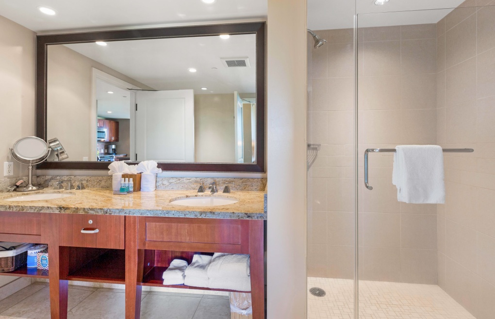 The guest bath offers a double granite vanity and a glass walk-in shower